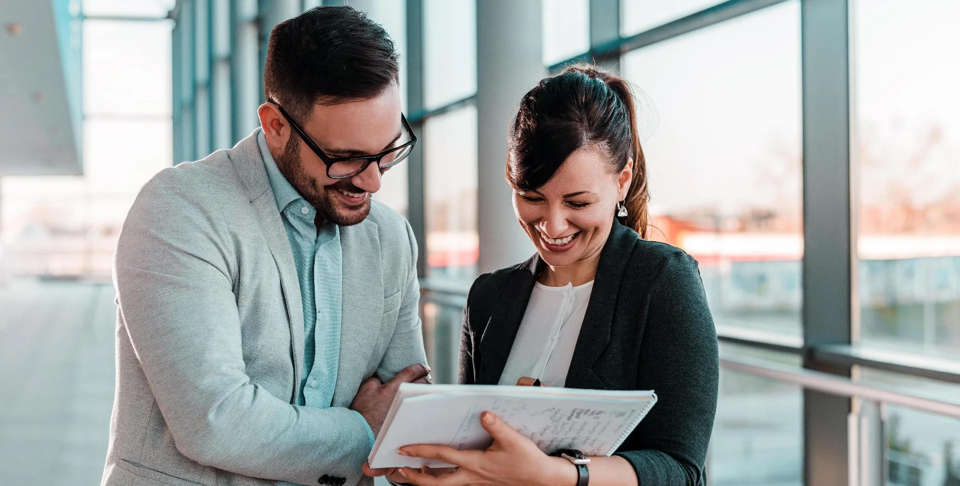 Two professionals reviewing a screening report together